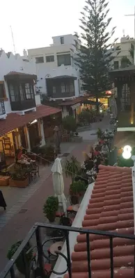 a view of a street with tables and buildings at Casa Poli Suites in Rhodes Town