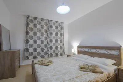 a bedroom with a bed with shoes on it at The Olive Garden House in Haraki