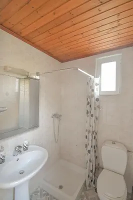 a bathroom with a sink and a toilet at The Olive Garden House in Haraki
