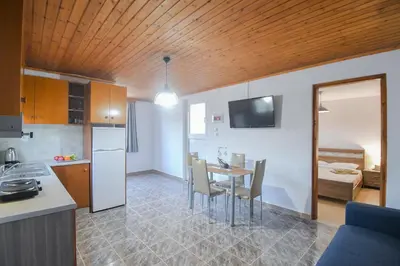 a kitchen and dining room with a table and chairs at The Olive Garden House in Haraki