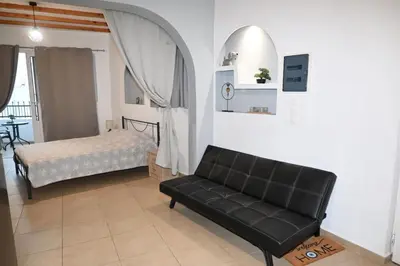 a living room with a couch and a bed at BEAUTIFUL HOUSE OF PSINTHOS in Psinthos