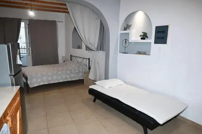 a bedroom with two beds and a refrigerator at BEAUTIFUL HOUSE OF PSINTHOS in Psinthos