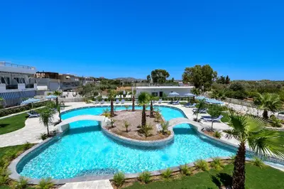 an overhead view of a swimming pool with palm trees at Paradise Garden in Kolimbia