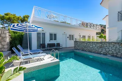 a villa with a swimming pool and a house at Paradise Garden in Kolimbia