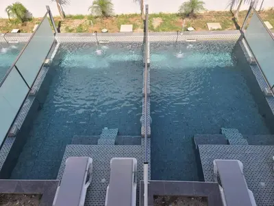 a swimming pool with chairs in the water at Paradise Garden in Kolimbia