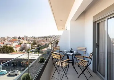 a balcony with a table and chairs and a view at MIRAGE city APARTMENTS in Rhodes Town