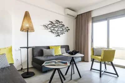 a living room with a couch and a table at MIRAGE city APARTMENTS in Rhodes Town