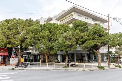 a building with trees in front of a street at MIRAGE city APARTMENTS in Rhodes Town