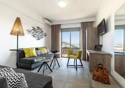 a living room with a couch and a table at MIRAGE city APARTMENTS in Rhodes Town