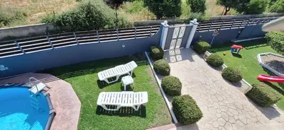 an aerial view of two white benches and a swimming pool at Rhodian Villa in Kremasti