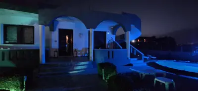 a house with a swimming pool at night at Rhodian Villa in Kremasti