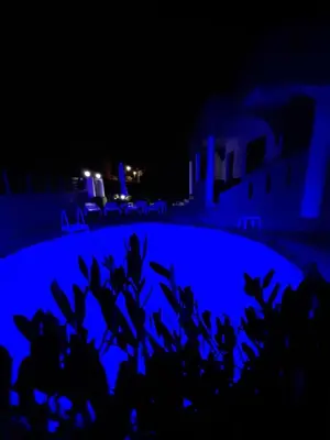 a night view of a pool with blue lights at Rhodian Villa in Kremasti