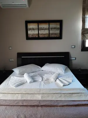 a bed with two towels on top of it at Rhodian Villa in Kremasti