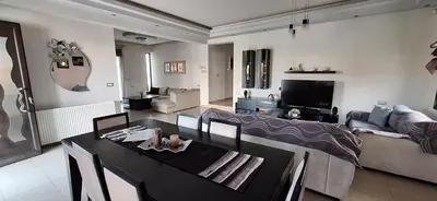a living room with a table and a couch at Rhodian Villa in Kremasti
