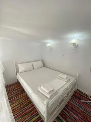 a white bed with two towels on it in a room at Pontamos Villas in Halki