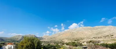 a view of a mountain range with houses and trees at Pontamos Villas in Halki