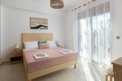 a bedroom with a bed with two towels on it at Ifigeneia Villa in Afantou