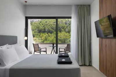 a hotel room with a bed and a large window at Atalanti Boutique Hotel - Adults Only in Faliraki