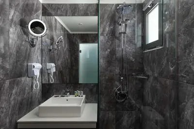 a bathroom with a sink and a shower at Atalanti Boutique Hotel - Adults Only in Faliraki
