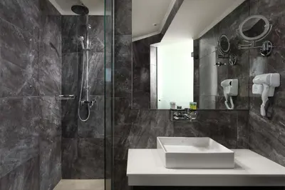 a bathroom with a sink and a shower at Atalanti Boutique Hotel - Adults Only in Faliraki