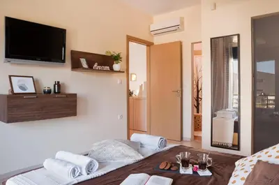 a living room with a flat screen tv on the wall at Green horizon villa in Asgourou