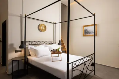 a bedroom with a four poster bed with white pillows at Villa Fluvian in Rhodes Town