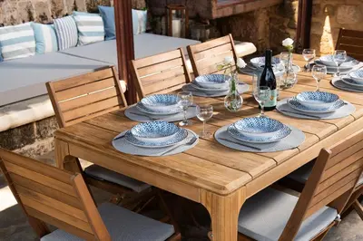 a wooden table with blue and white dishes on it at Villa Fluvian in Rhodes Town
