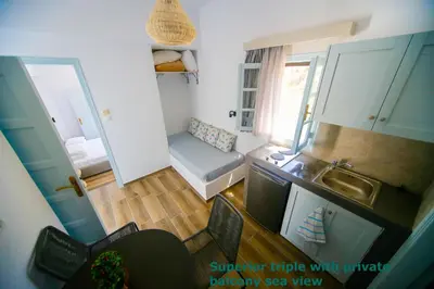 a small room with a kitchen and a sink at St. Paul's Bay View Suites in Líndos