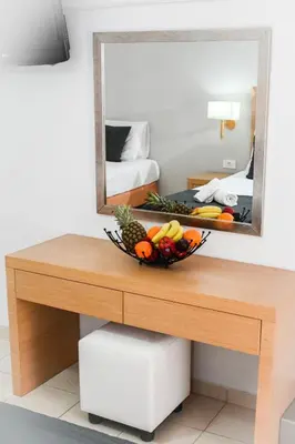 a bowl of fruit on a table in front of a mirror at ANGELA STUDIOS in Kremasti