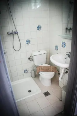 a bathroom with a toilet and a sink at ANGELA STUDIOS in Kremasti