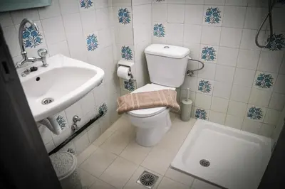 a bathroom with a toilet and a sink at ANGELA STUDIOS in Kremasti