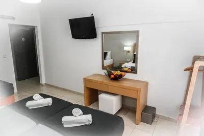 a room with a mirror and a table with towels at ANGELA STUDIOS in Kremasti