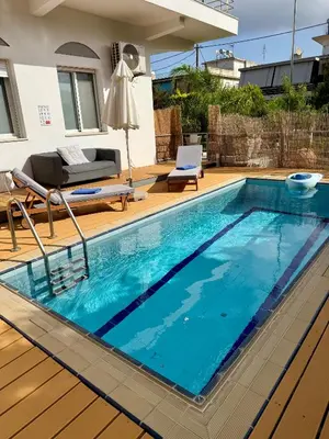 a swimming pool with blue water in a house at Villa 56 Luxury apartments in Rhodes Town