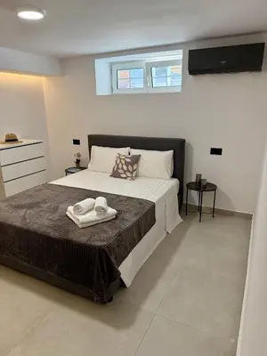 a bedroom with a bed with two towels on it at Villa 56 Luxury apartments in Rhodes Town