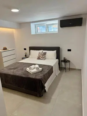 a bedroom with a bed with two towels on it at Villa 56 Luxury apartments in Rhodes Town