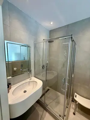 a bathroom with a glass shower and a sink at Villa 56 Luxury apartments in Rhodes Town