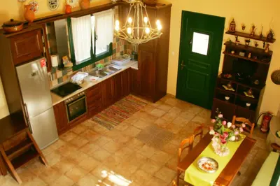 an overhead view of a kitchen with a table and a refrigerator at Dora's House in Ístrios