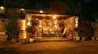 a patio with a table and chairs and lights at Dora's House in Ístrios