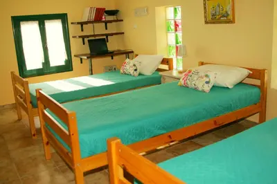 a room with three beds in a room at Dora's House in Ístrios