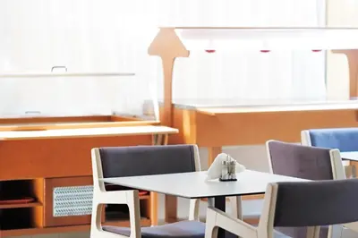 a table and chairs with a piano in a room at Savoy City Hotel in Rhodes Town