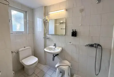 a bathroom with a toilet and a sink and a shower at Savoy City Hotel in Rhodes Town
