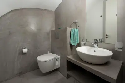 a bathroom with a white toilet and a sink at Luxury Villa Hera with Private Pool in Afantou