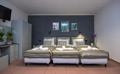 a bedroom with two beds in a room at Kahlua Hotel Apartments in Rhodes Town