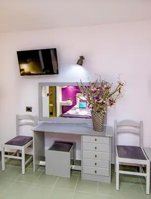 a desk with two chairs and a mirror at Kahlua Hotel Apartments in Rhodes Town