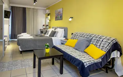 a hotel room with a bed and a couch at Kahlua Hotel Apartments in Rhodes Town