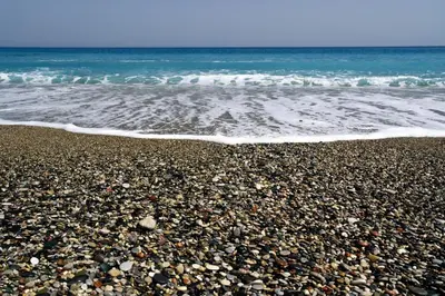 a rocky beach with the ocean and the waves at Colourful Home, Medieval Town Rhodes in Rhodes Town