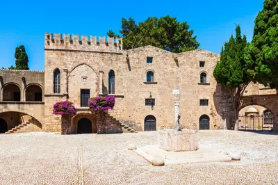 a large brick building with a fountain in front of it at Colourful Home, Medieval Town Rhodes in Rhodes Town