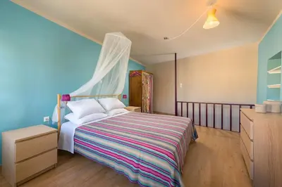 a bedroom with a bed with a blue wall at Colourful Home, Medieval Town Rhodes in Rhodes Town