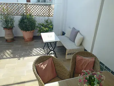 a patio with chairs and a table and a bench at Nikelen Lindian Exclusive Apartments in Líndos
