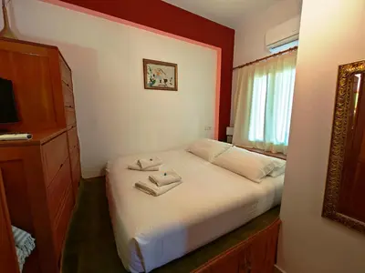 a bedroom with a bed with two towels on it at Nikelen Lindian Exclusive Apartments in Líndos